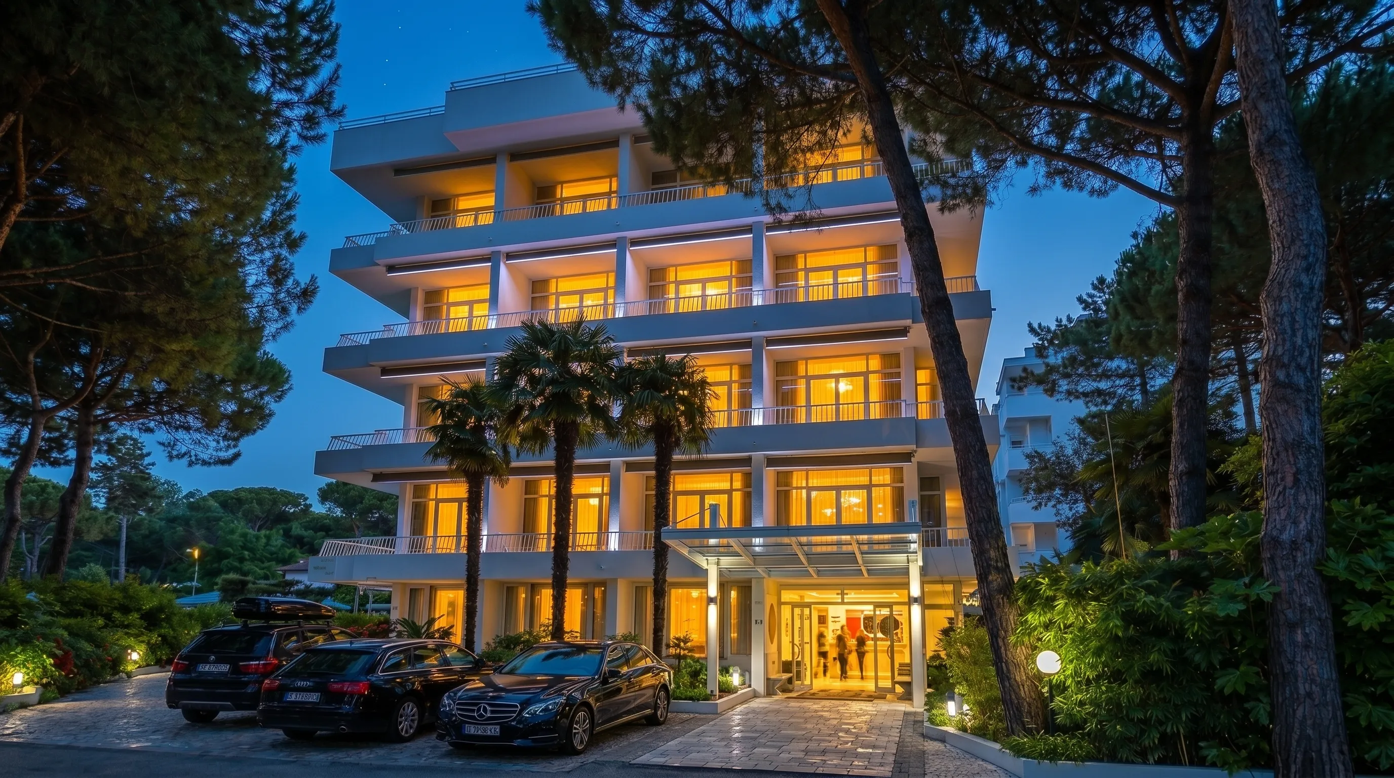 Greif Hotel at blue hour with warm windows and garden lights